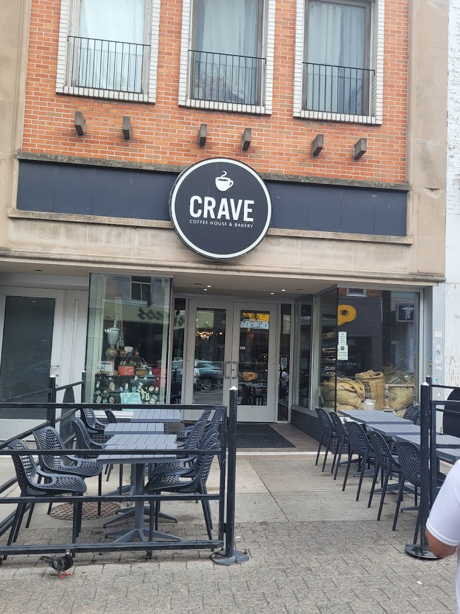 CRAVE’s round black sign above its red-brick Princess Street storefront