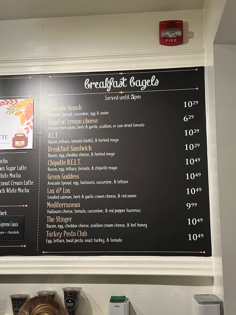CRAVE breakfast bagel menu board with ten bagels and prices
